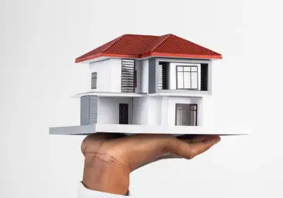 a hand carrying a house
